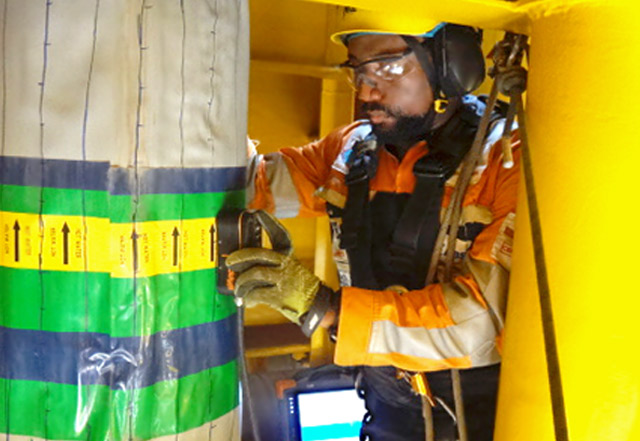 RusselSmith Inspector performing a Pilsed Eddy Current Inspection